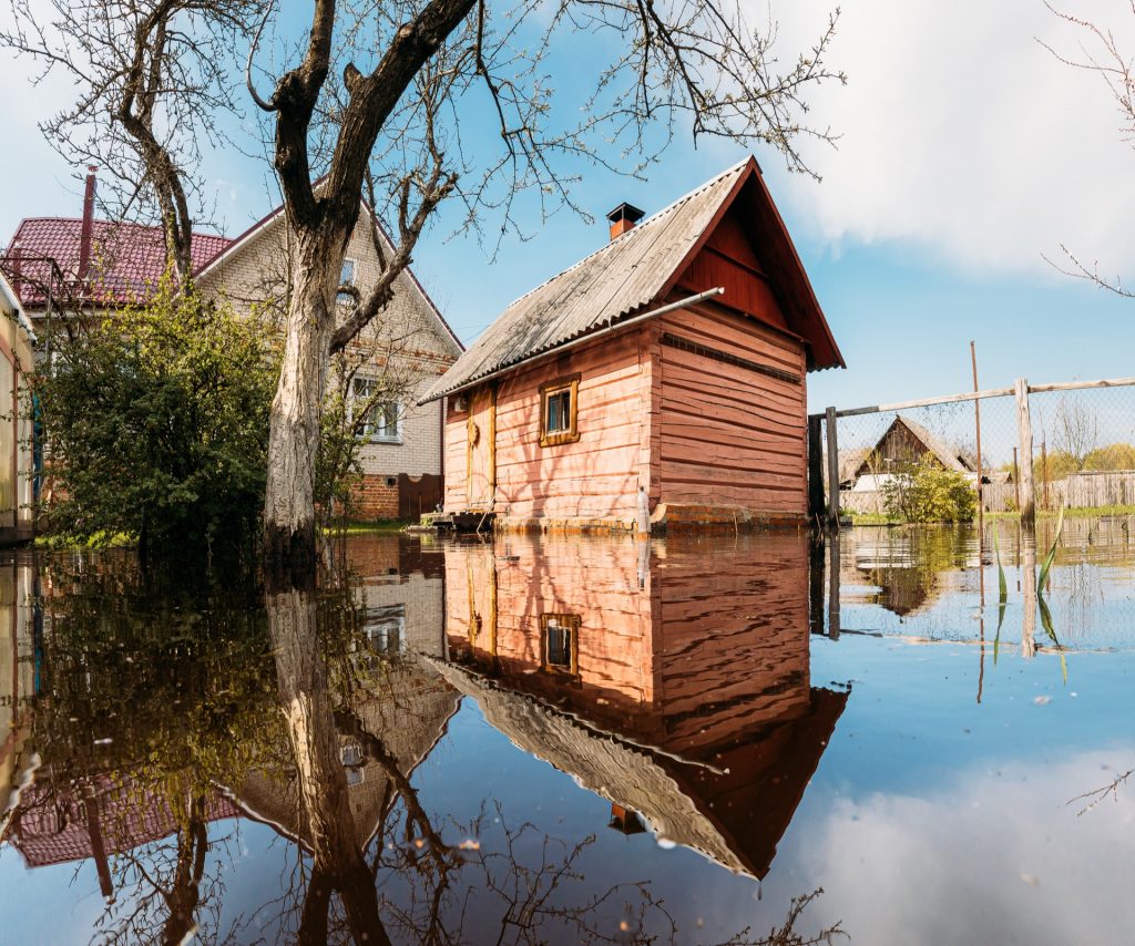 Holzgebaeude im Hochwasser - Ueberschwemmungsschutz bei Starkregen fuer Ferienhaeuser